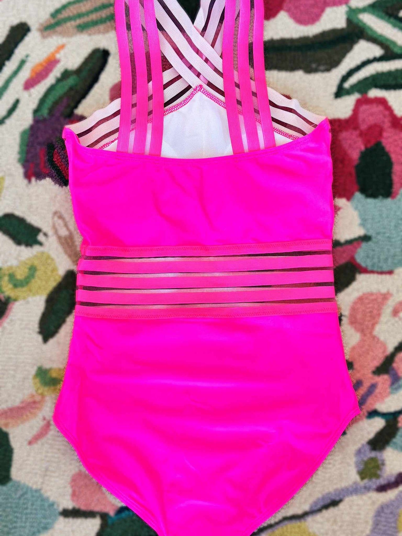 Pink one piece bathing suit with sheer stripe design.