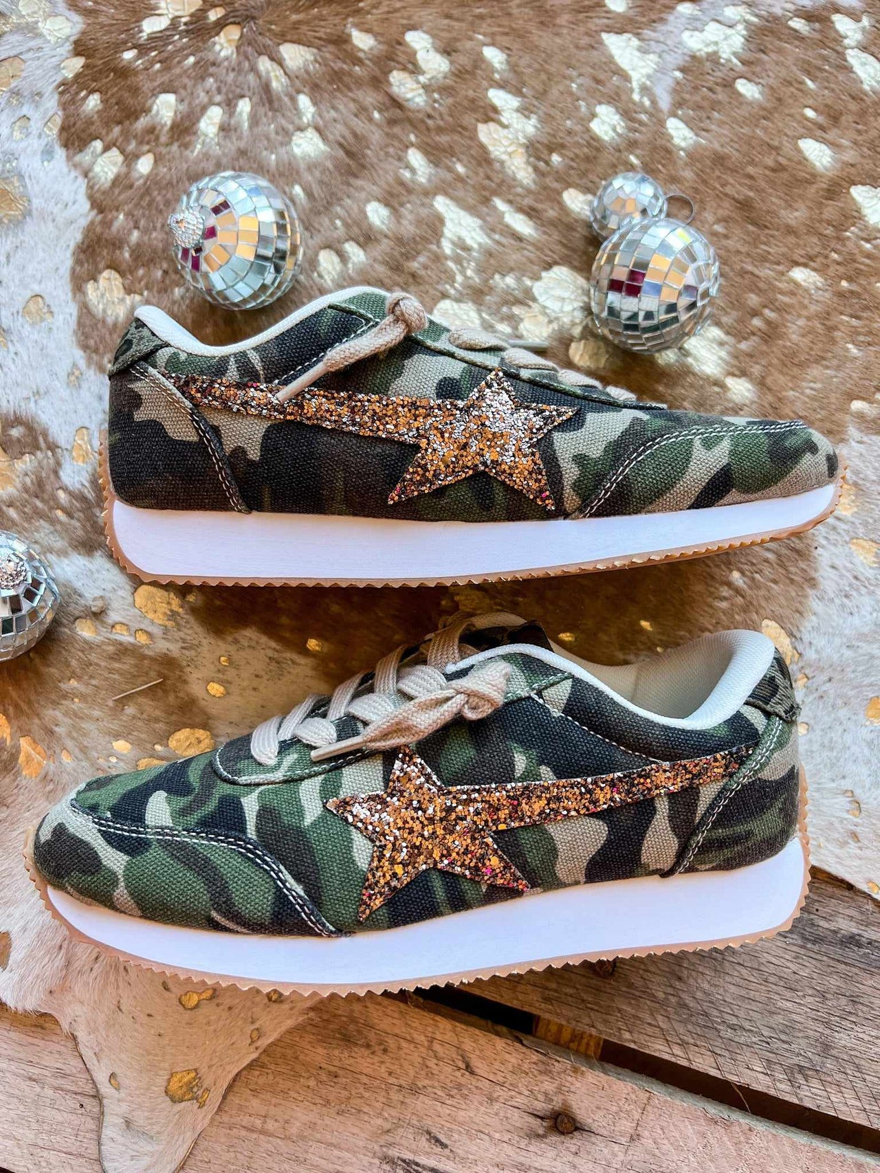 Camo sneakers with gold star.
