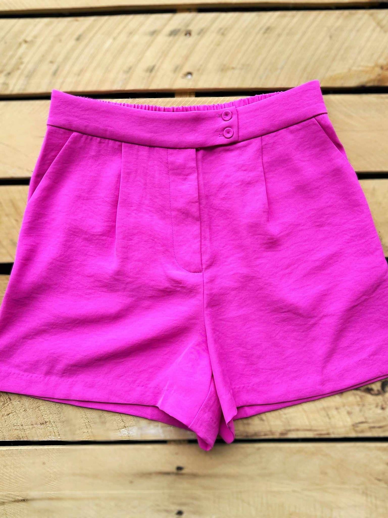 Pink pleated tailored shorts made with recycled materials