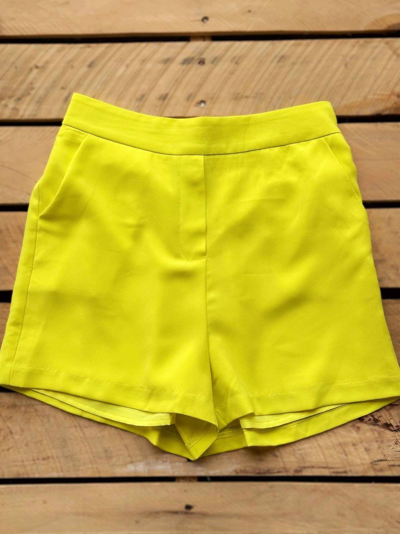 Yellow tailored flat front shorts.