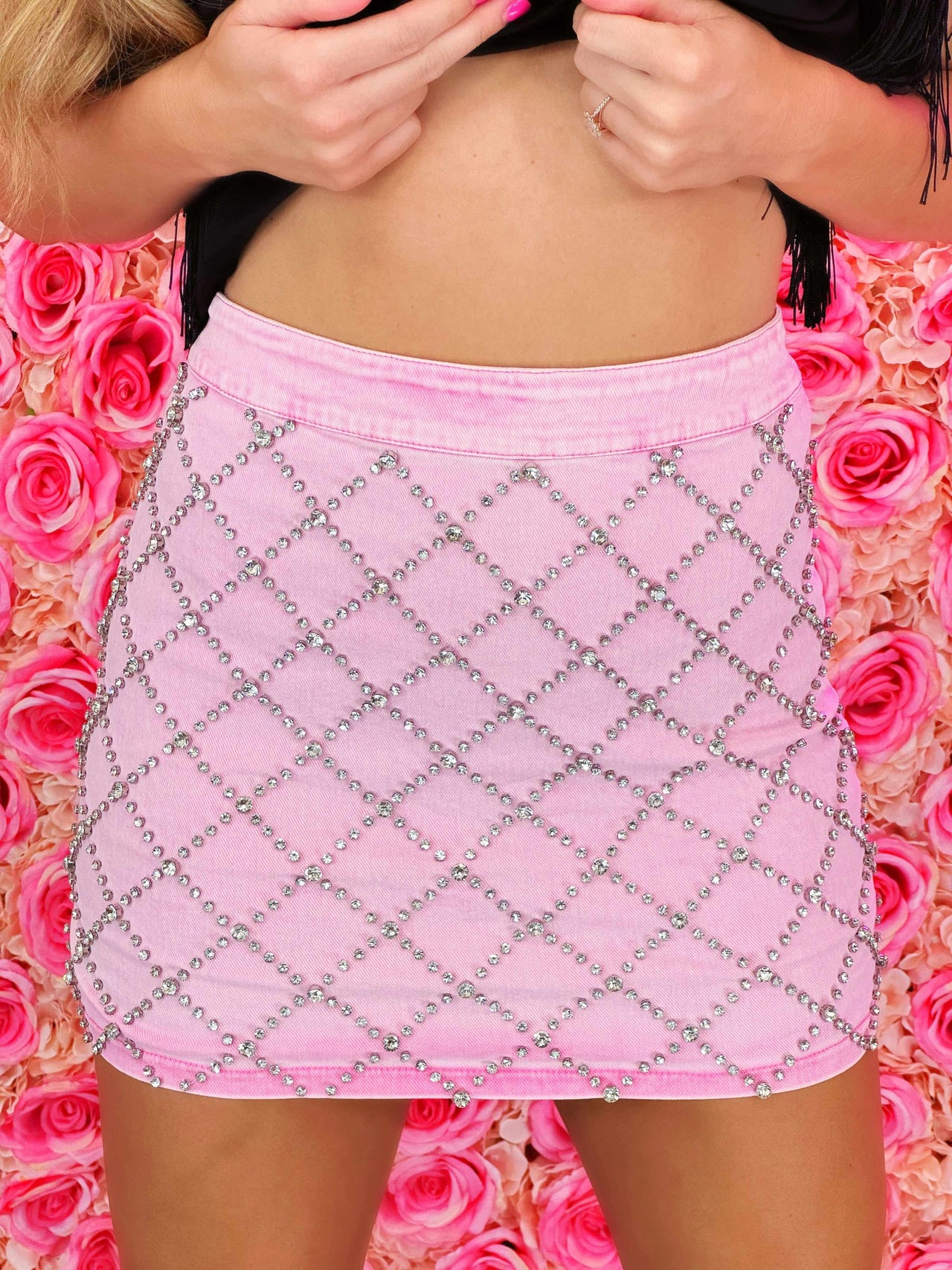 Pink denim skirt with rhinestone pattern.