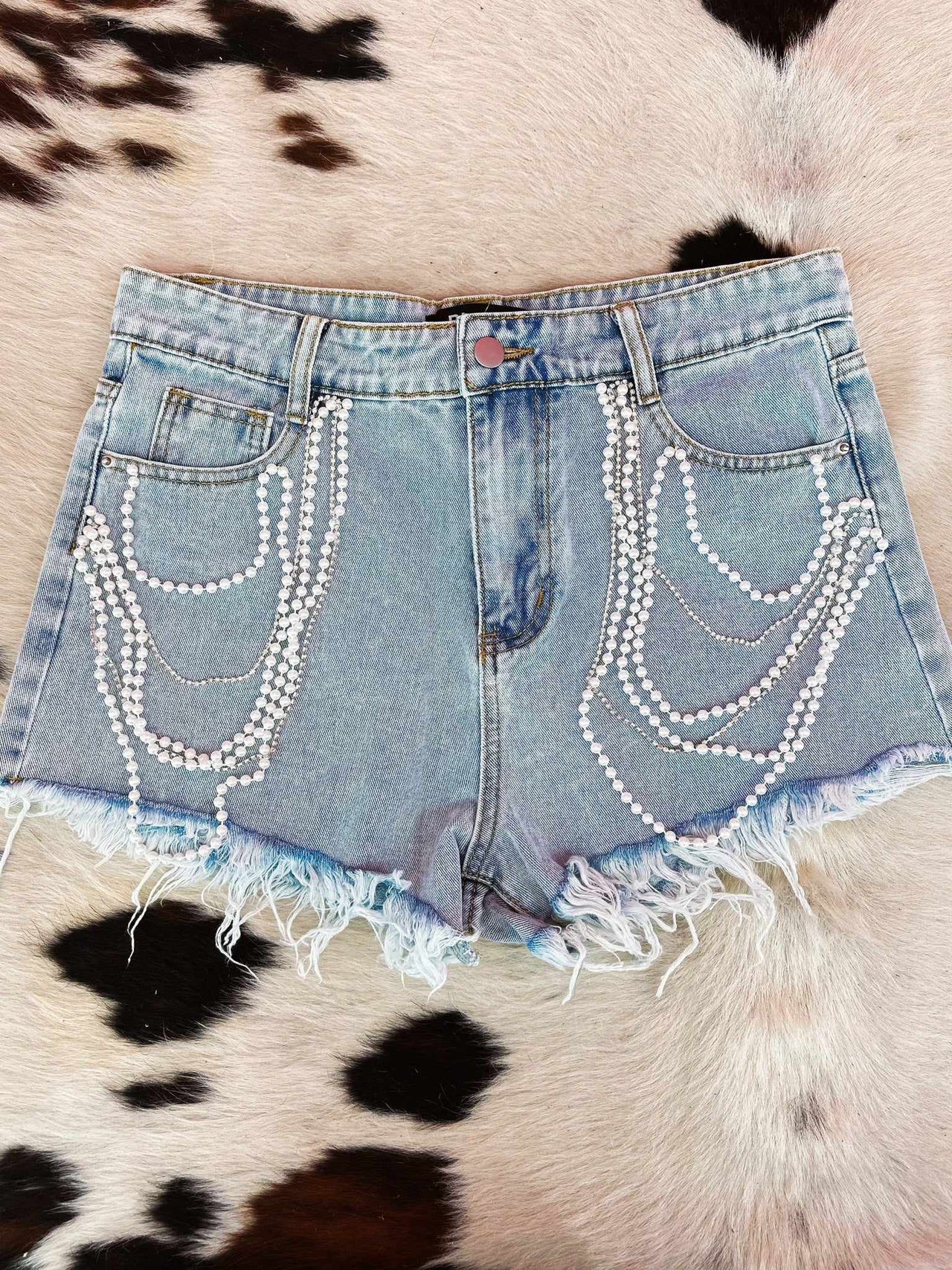 Distressed jean shorts with pearls chain