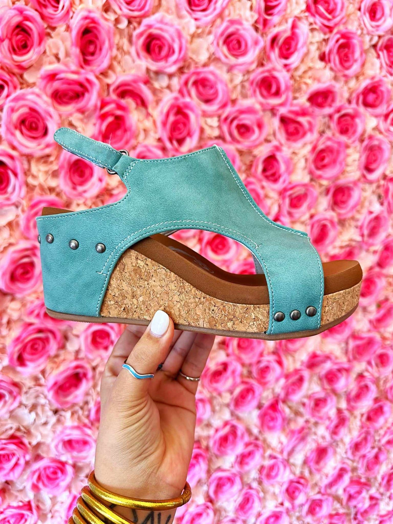 Turquoise suede wedge sandal.