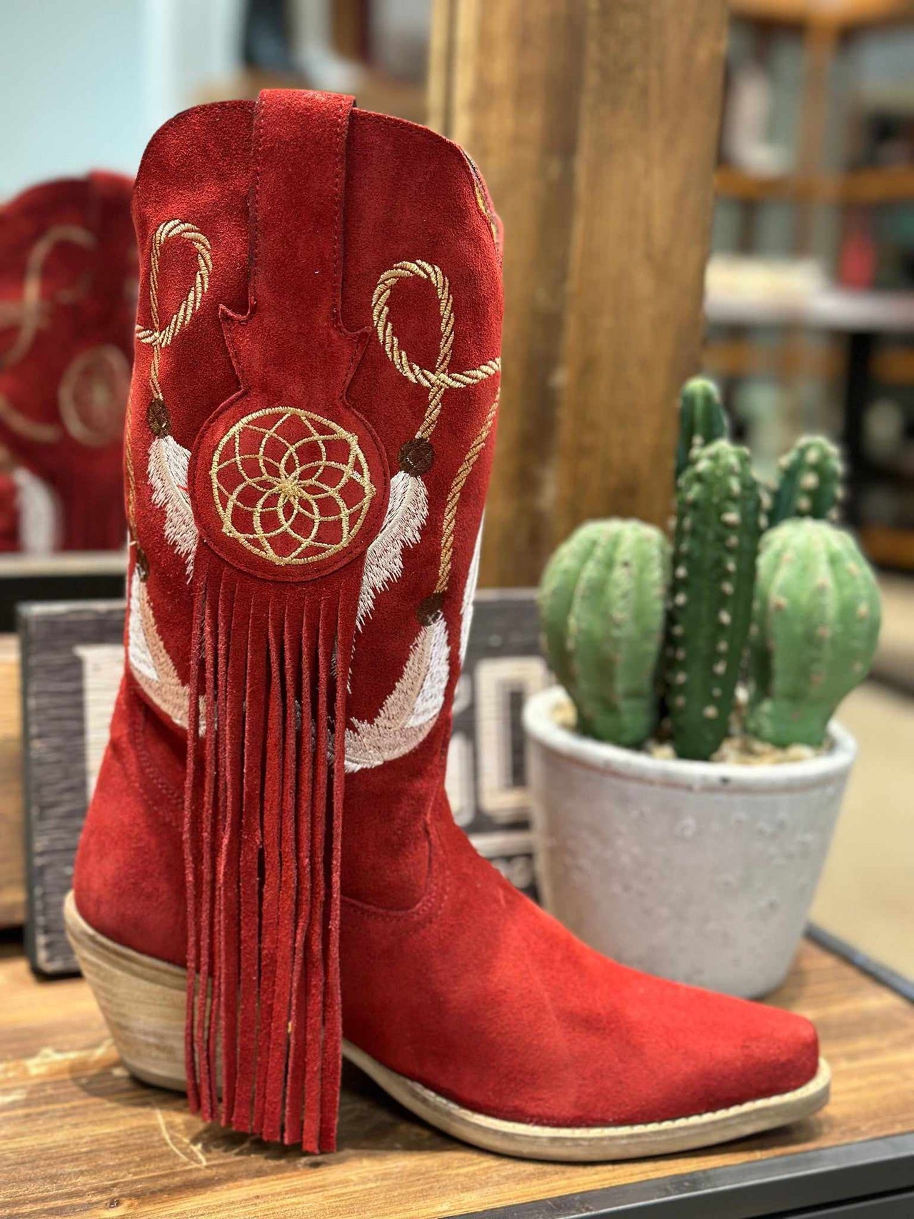 Feather embroidered red suede western boots with fringe. 