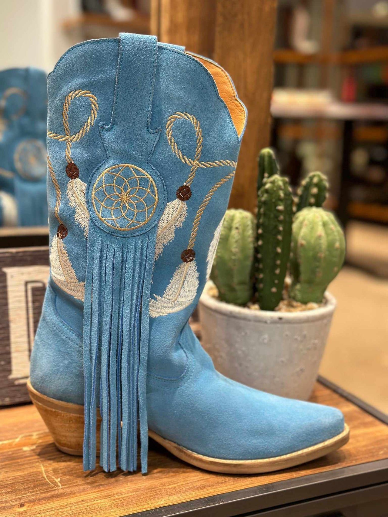 Light blue suede western boots with feather embroidery and fringe