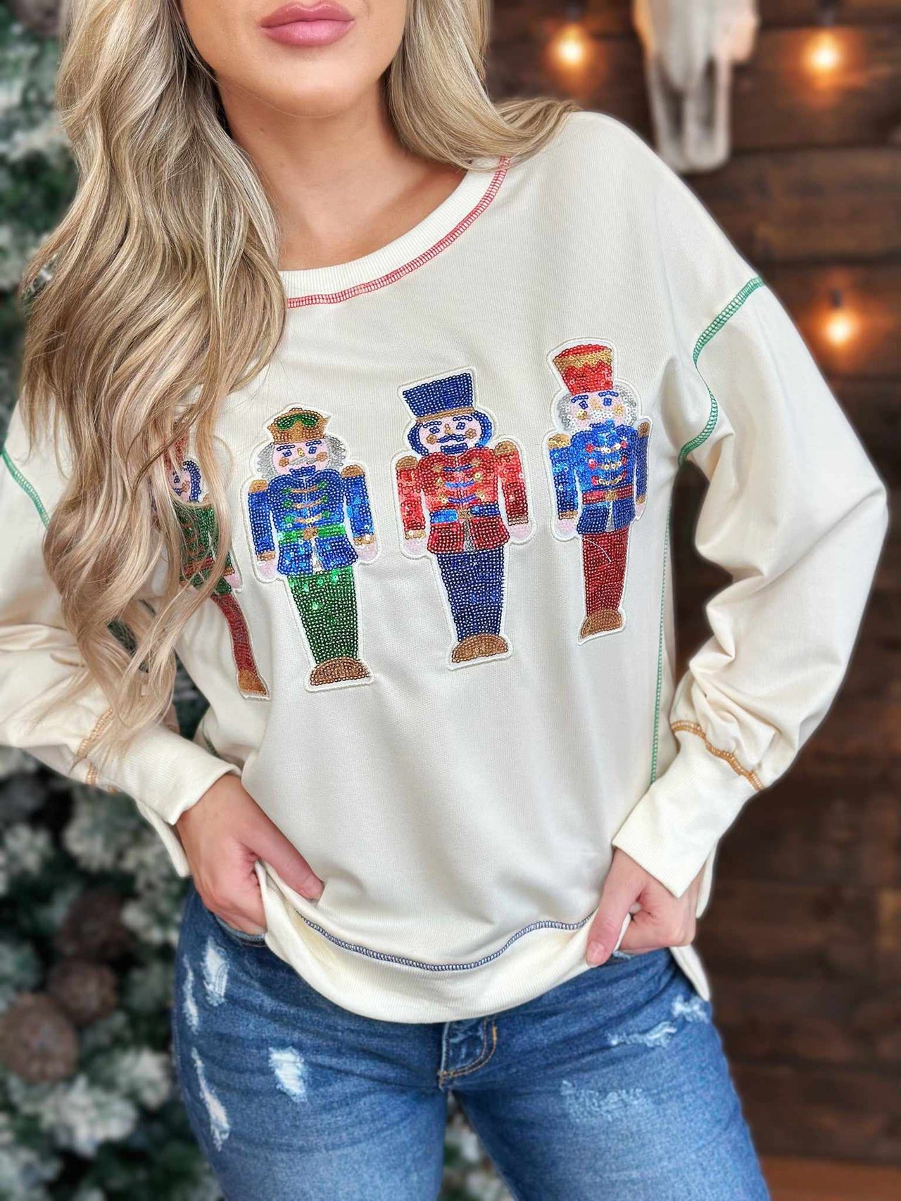 LIghweight cream pullover sweater with sequin nutcrackers