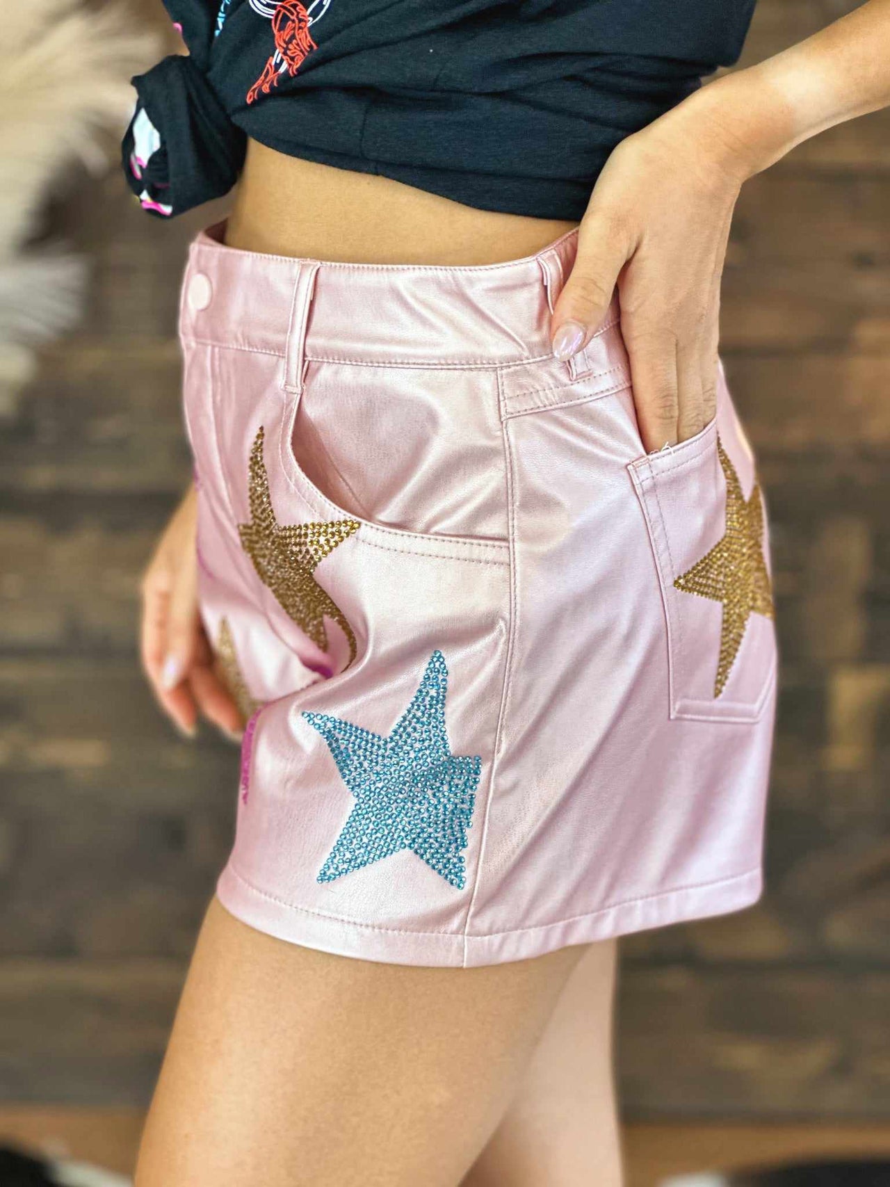 LIght pink metallic leather shorts with stars.