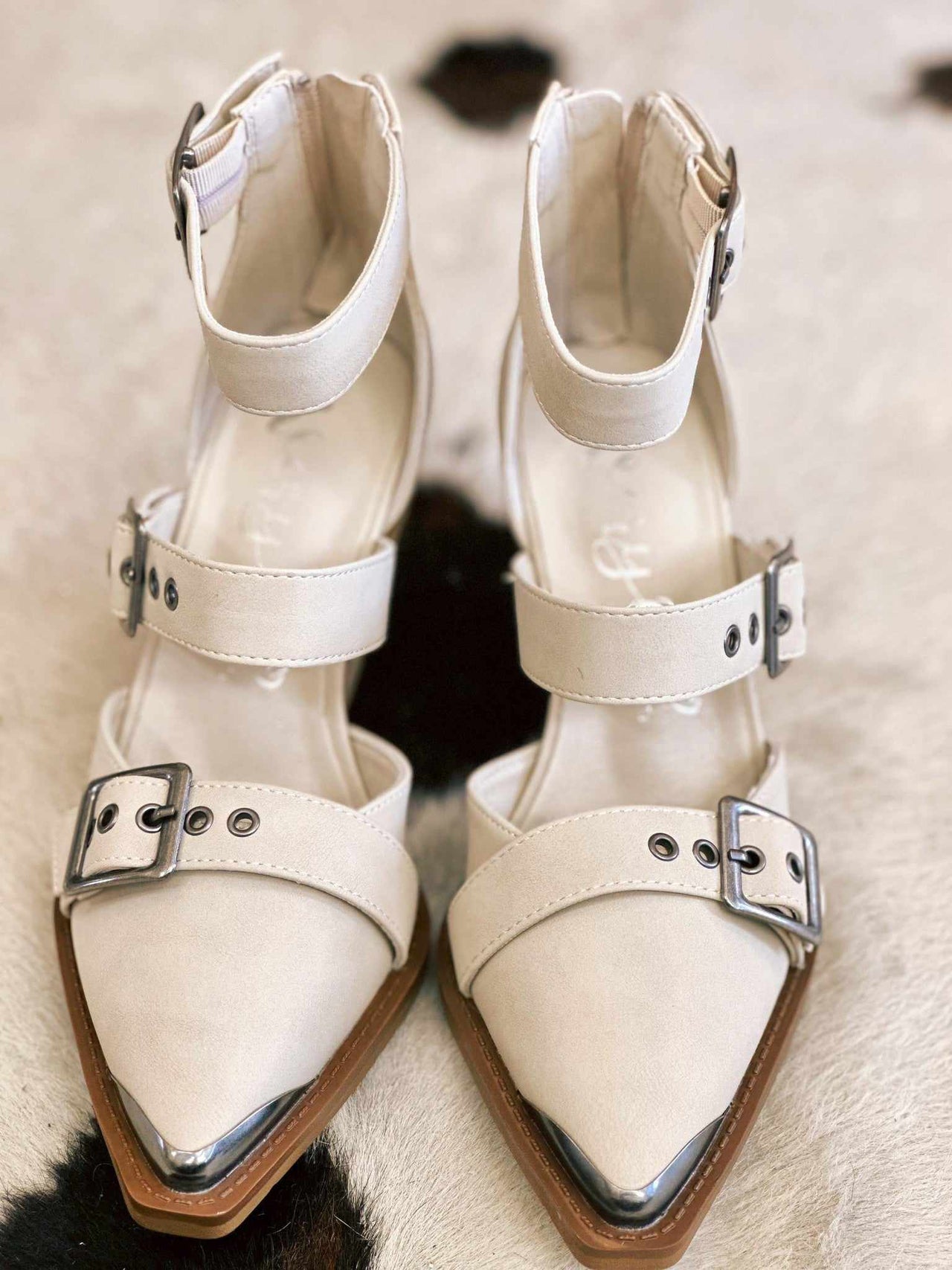 Cream ankle strap buckle heels.