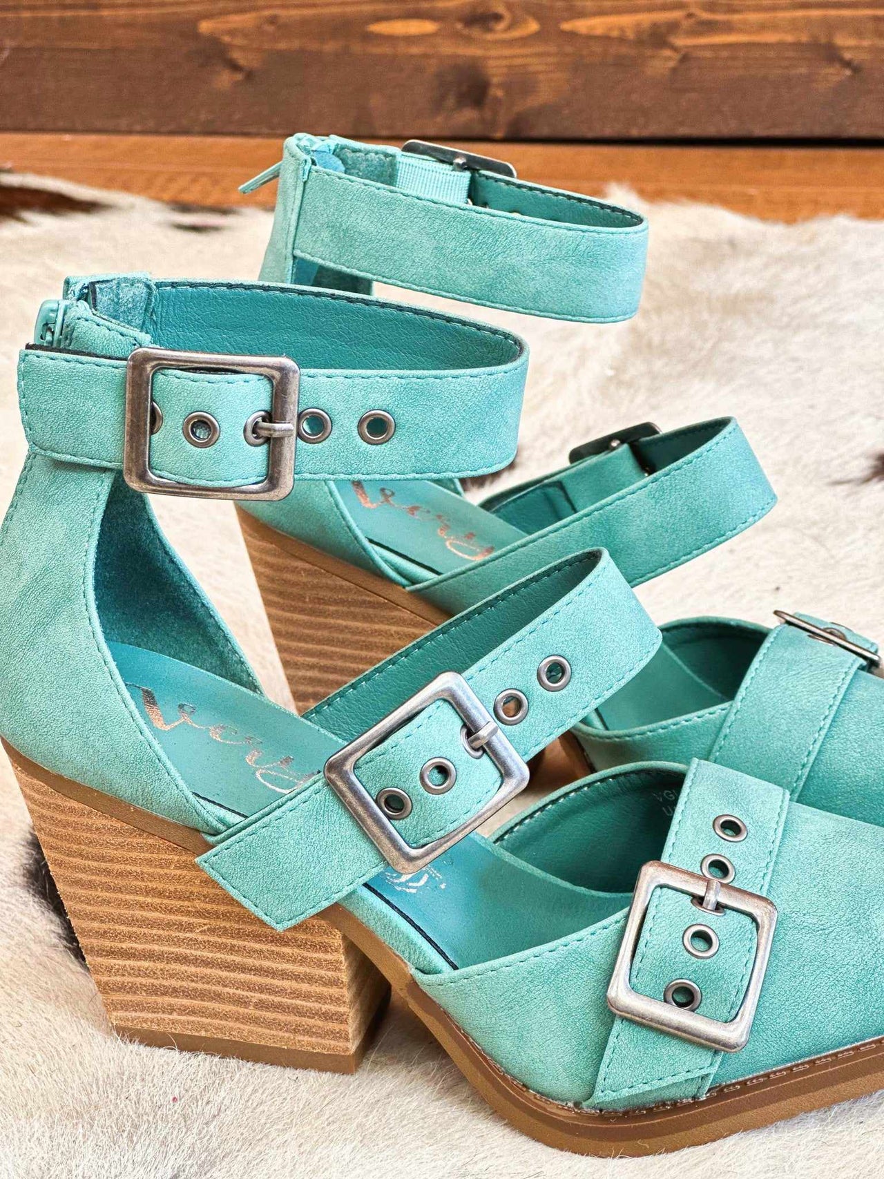 Double strap chunky heel turquoise shoes.
