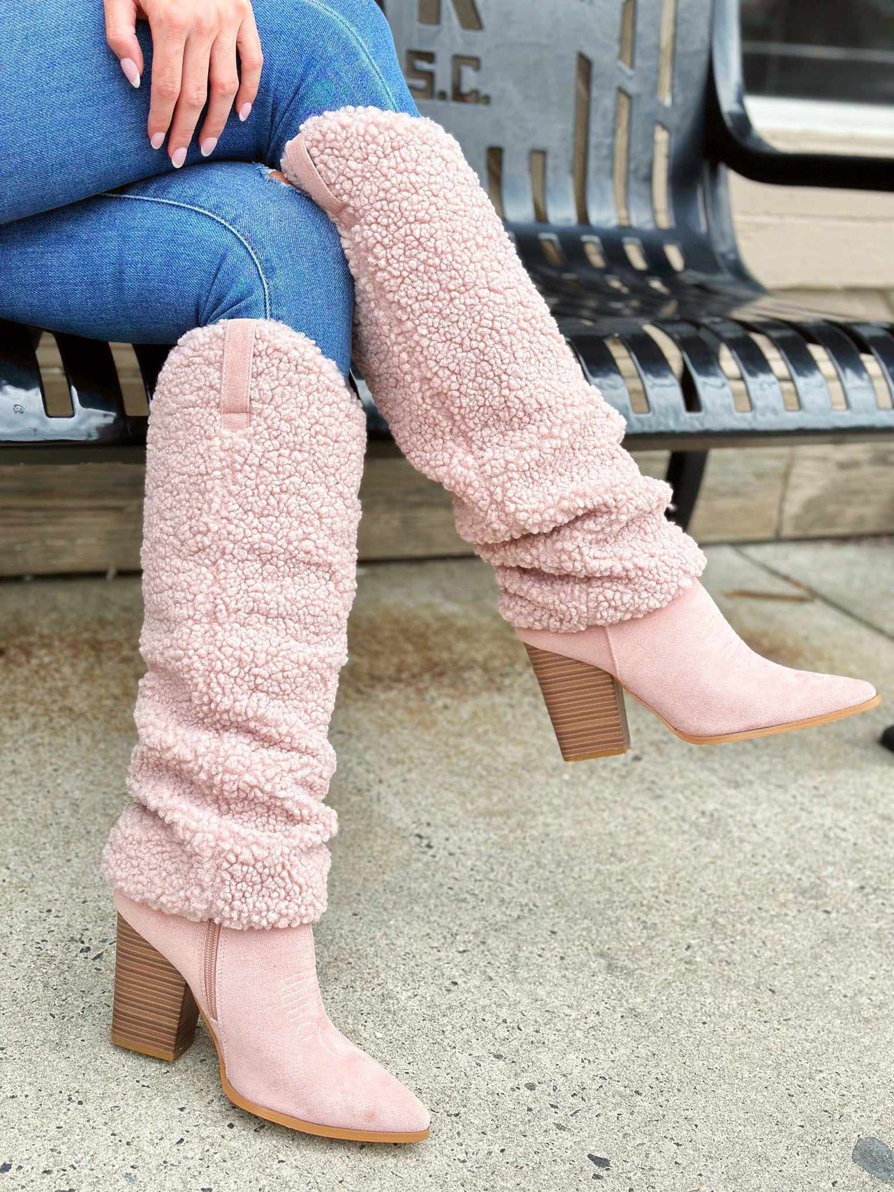 Pastel pink Sherpa knee high boots with heel.