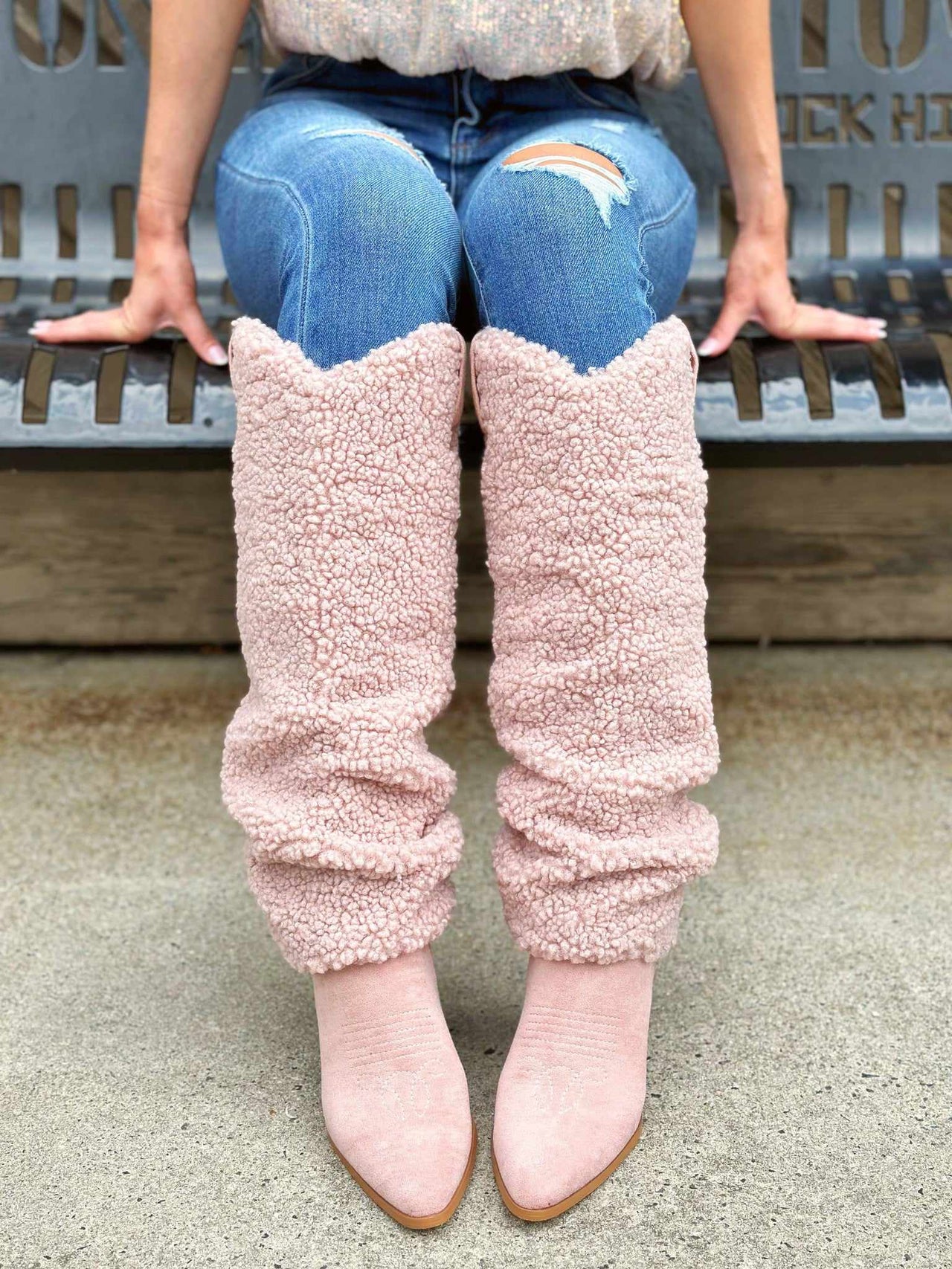 Sherpa sweater knee high boots in pink.