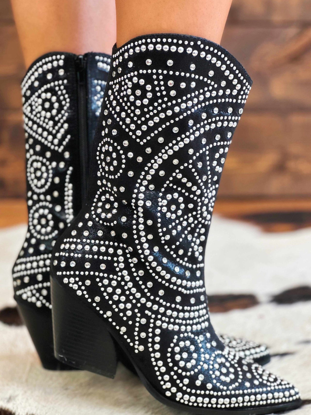 Short black western boots with rhinestone pattern.