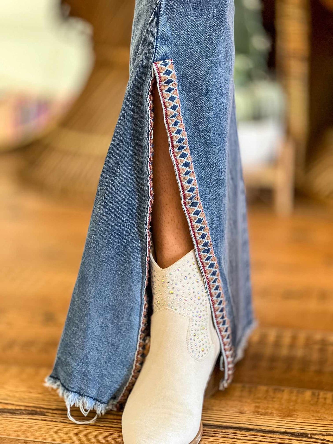 Embroidered bell bottom jeans with slit.