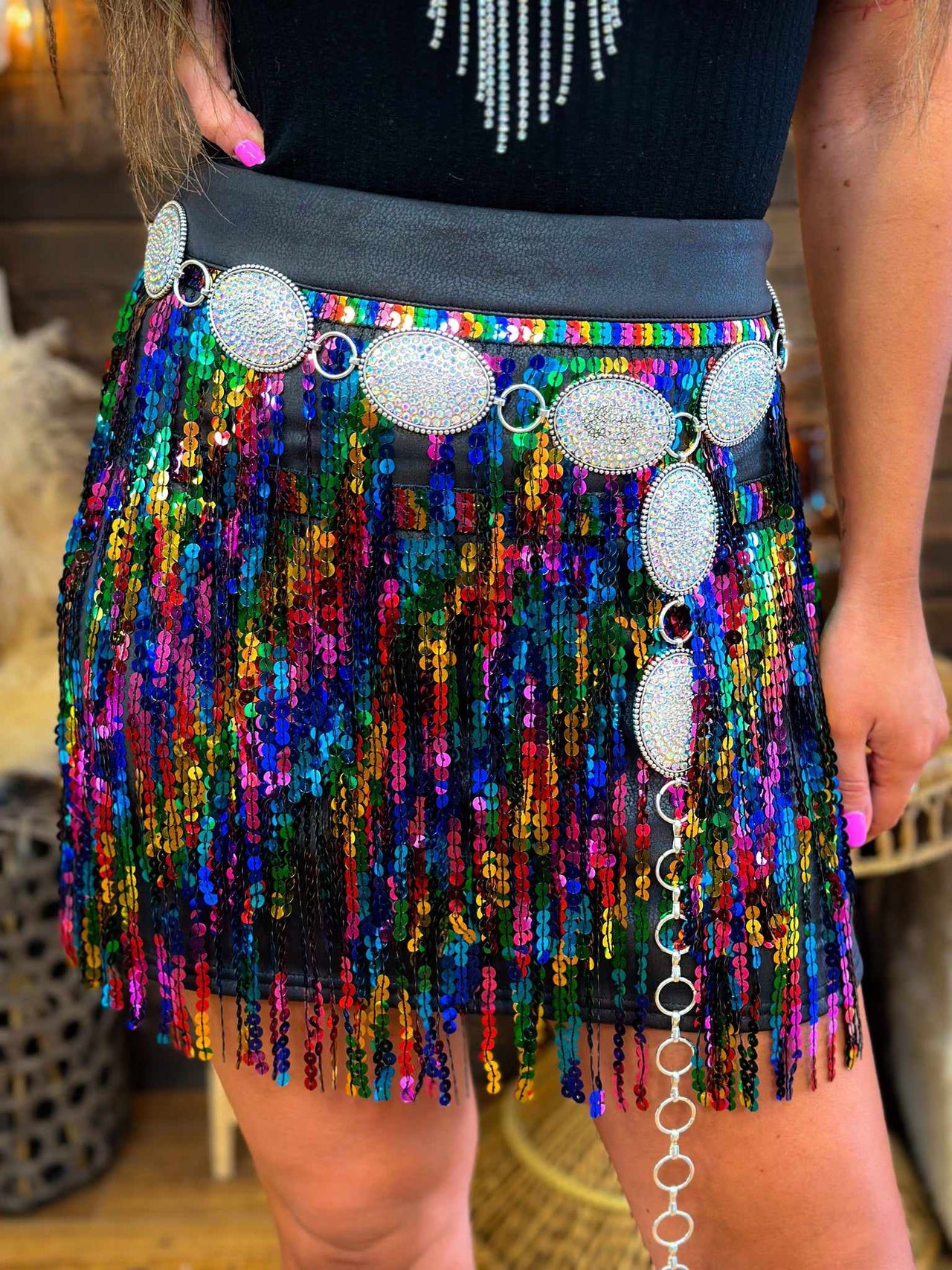 Mini skirt with tiered rainbow sequin overlay.