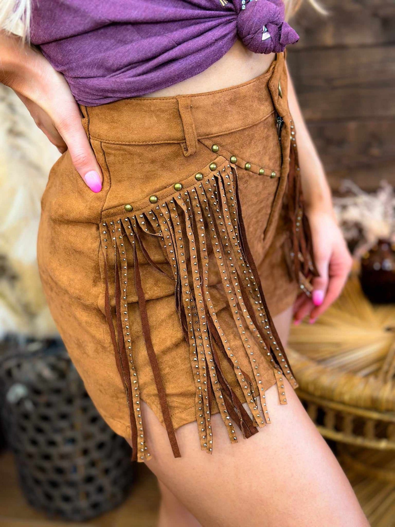 Western style brown sued shorts with studded fringe.