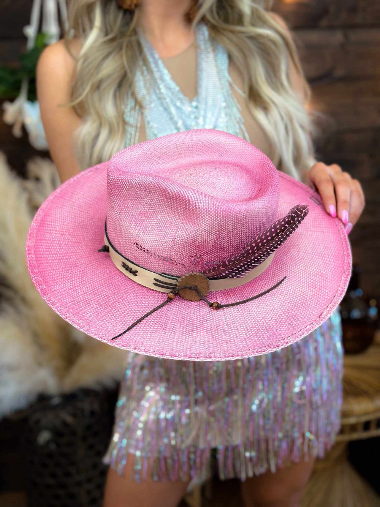 Distressed pink wide brim couture hat with feather.