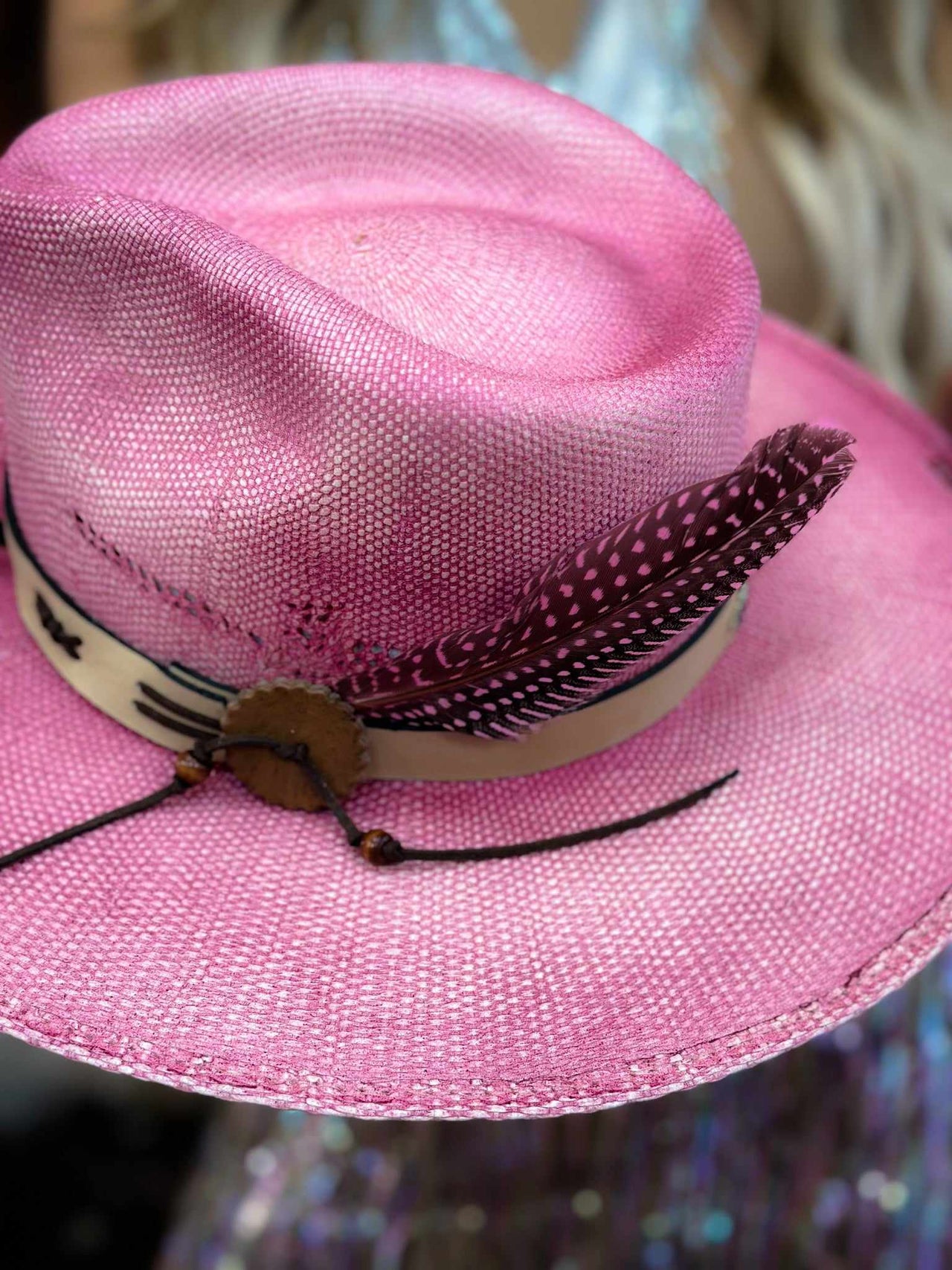 Pink wide brim hat.