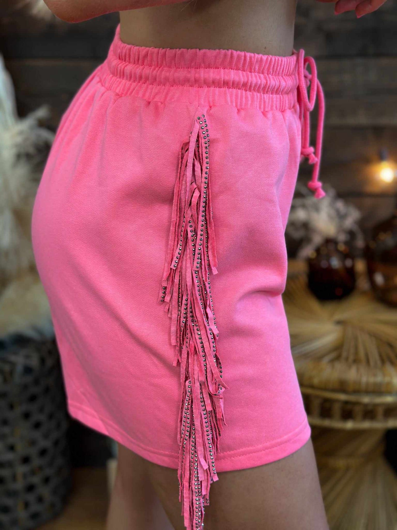 Pink French terrycloth shorts with western side fringe.