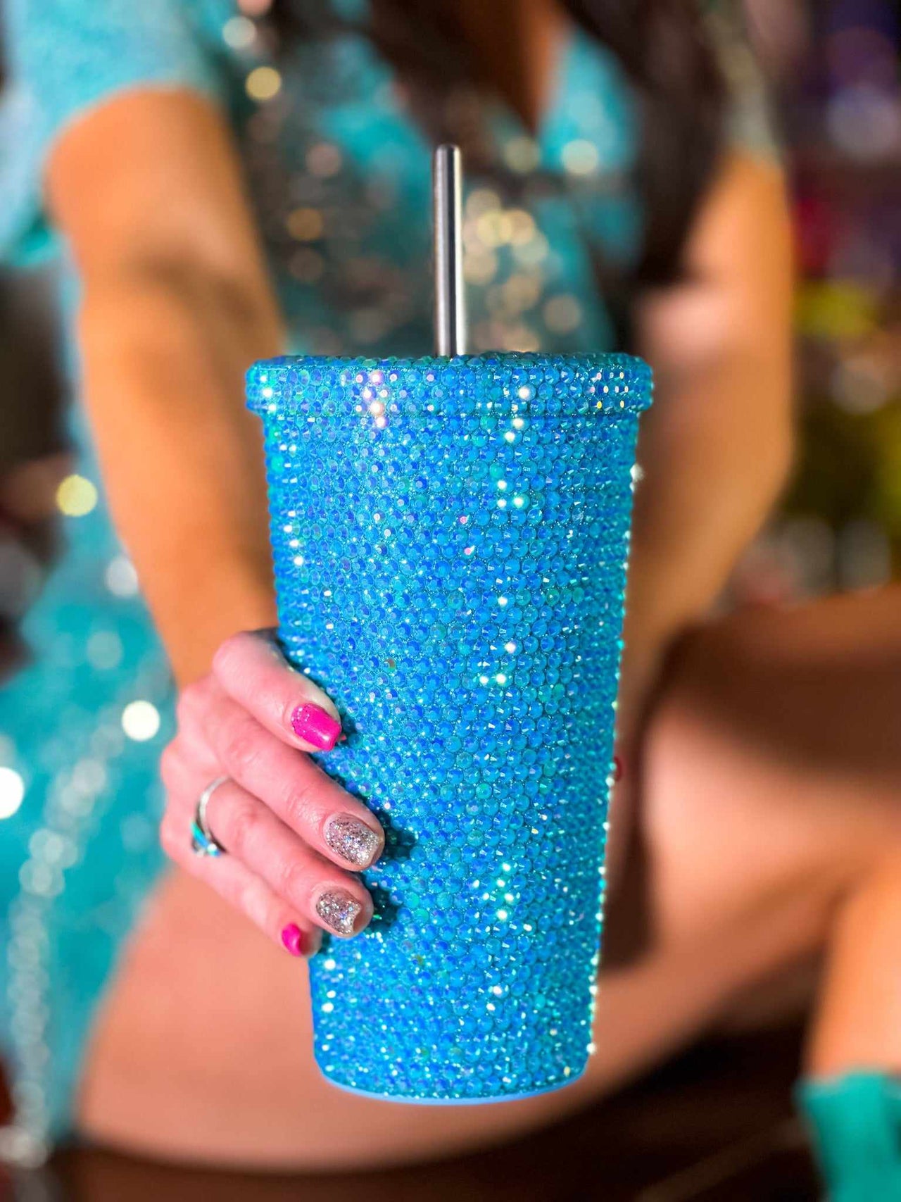 Turquoise rhinestone travel cup with stainless steel straw.