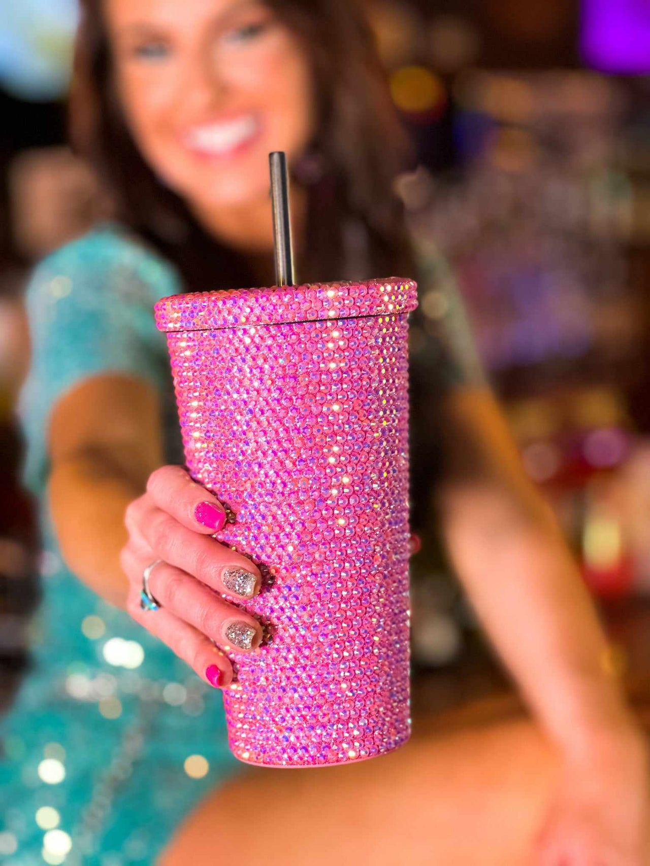 Pink rhinestone travel cup with straw.