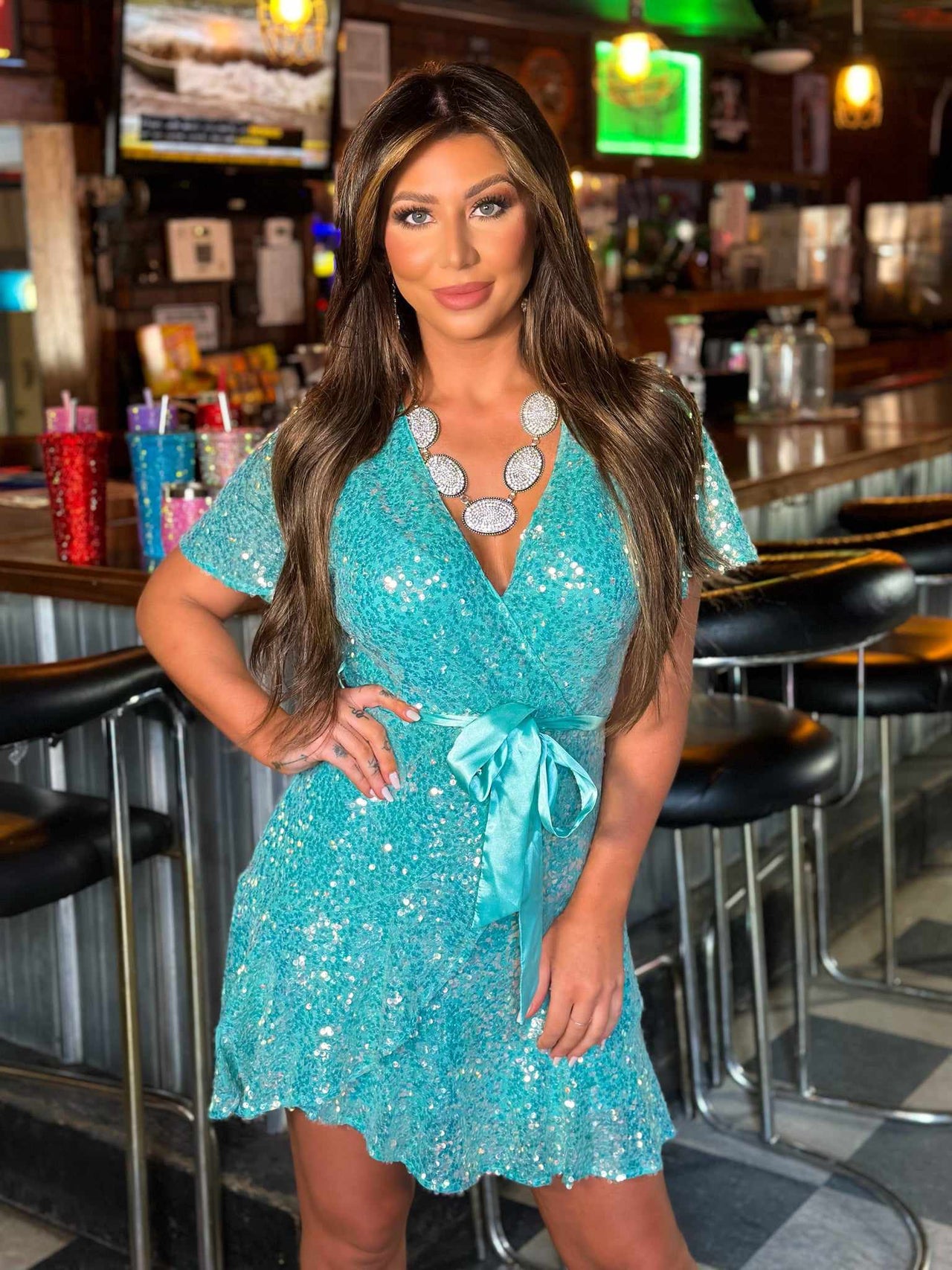 Sequin wrap dress in turquoise.
