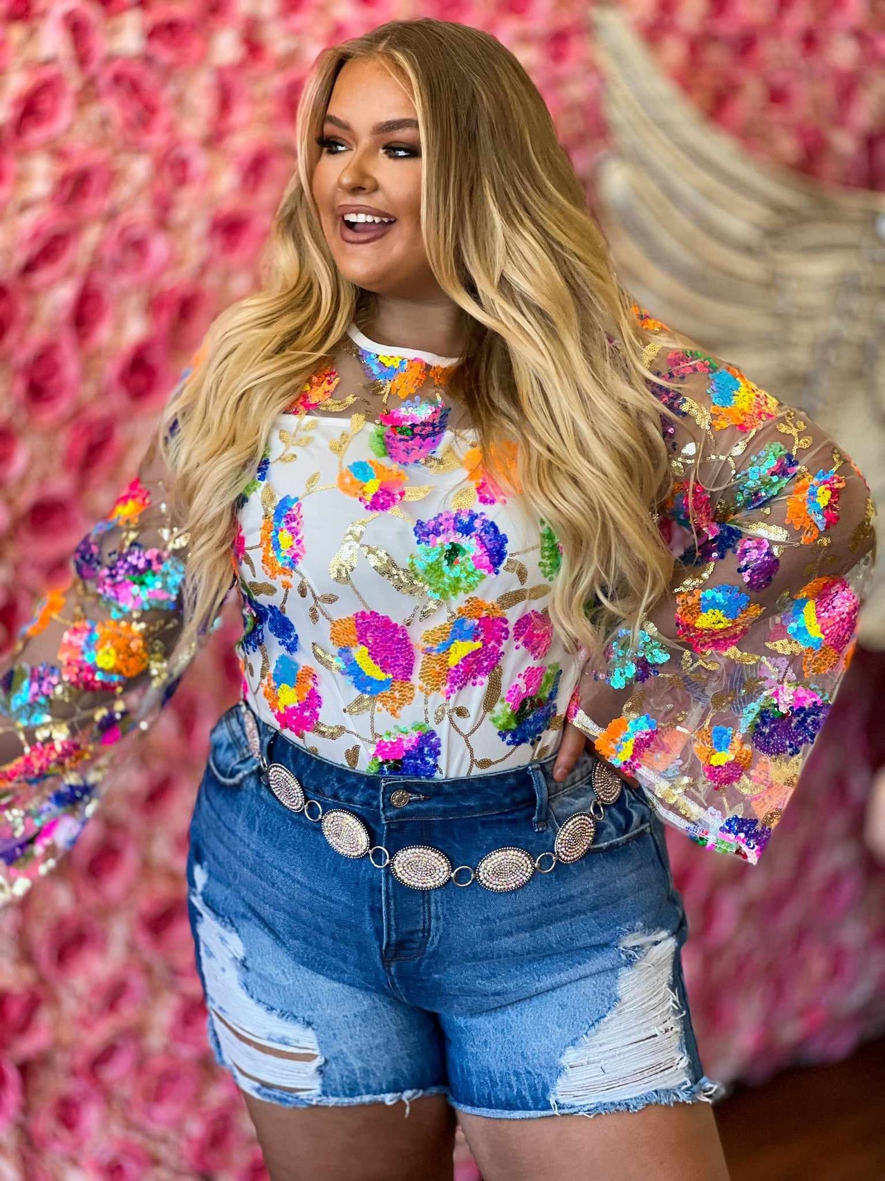 Plus size sheer overlay sequin floral top.