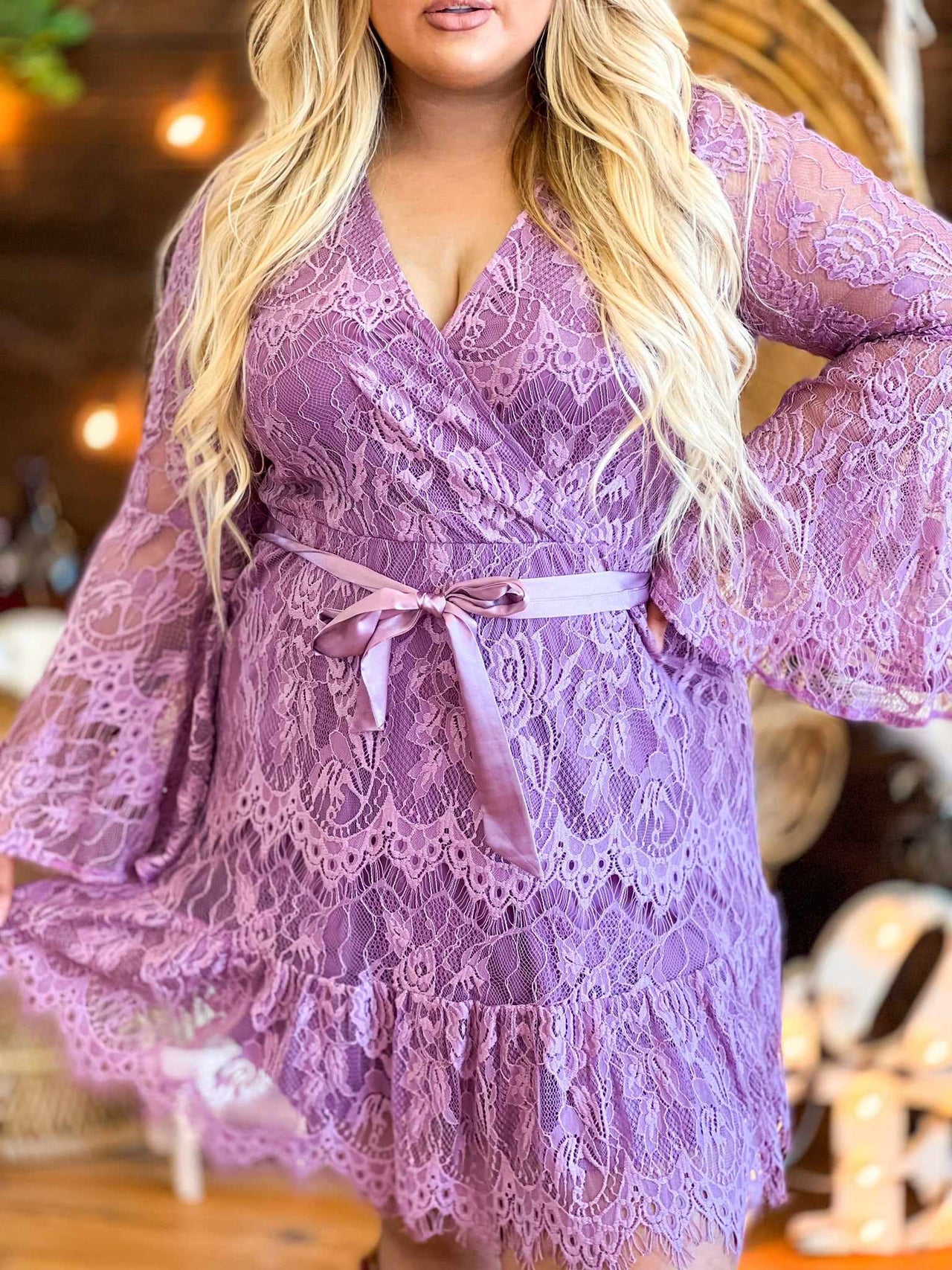 Purple lace dress with bell sleeves.