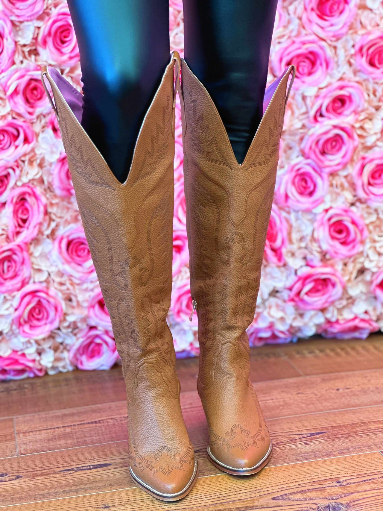 knee high cowgirl boots in brown.