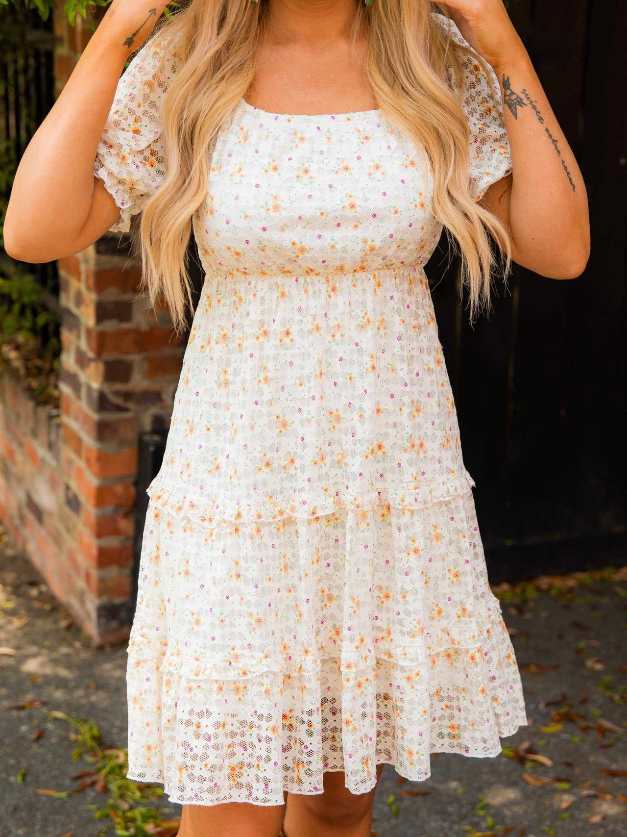White floral dress with lace and daisies.
