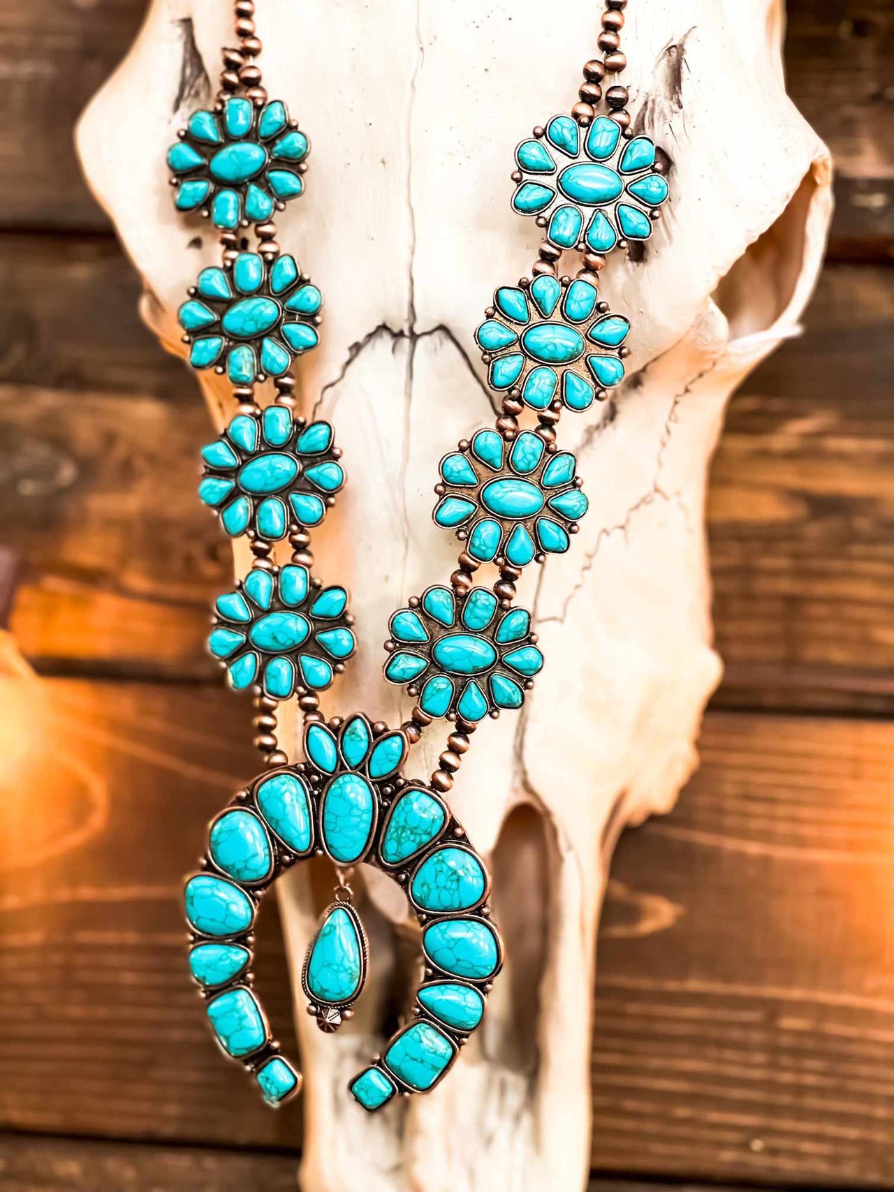Turquoise stone squash blossom necklace.