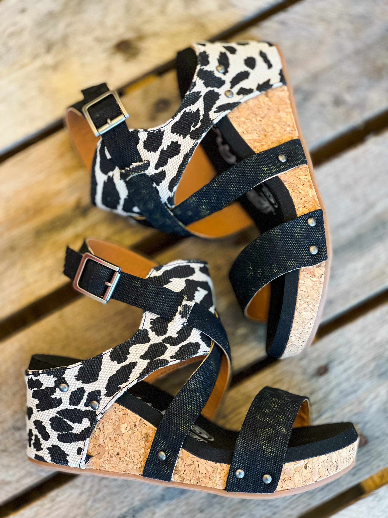 Black wedge sandal with leopard strap.